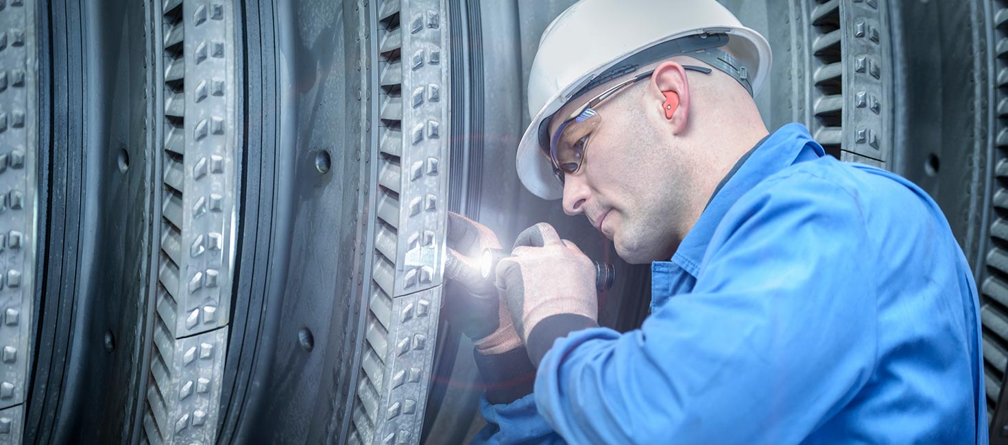 Technician inspecting machinery