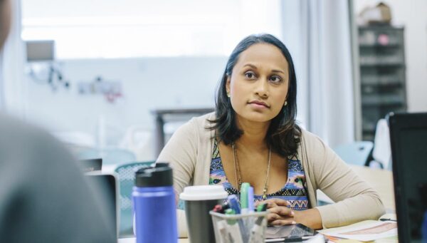 Health Sciences graduates discussing health care policy in a meeting