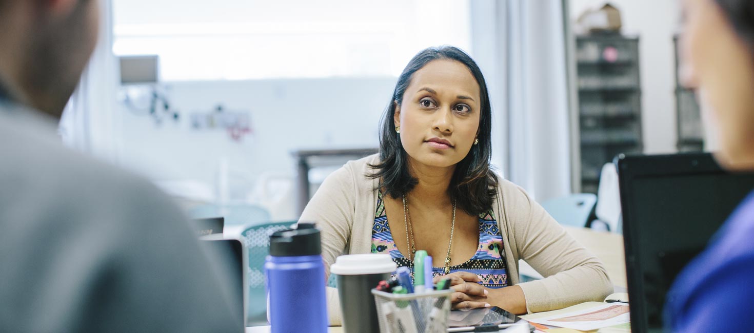 Health Sciences graduates discussing health care policy in a meeting