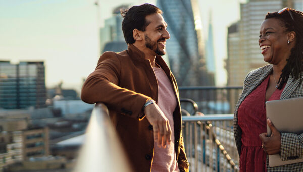 Business colleagues speaking on an urban roof deck